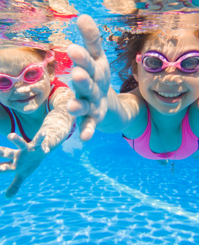 Happy kids swimming underwater in a pool kept clean and always ready for fun by Fil-Fresh filters