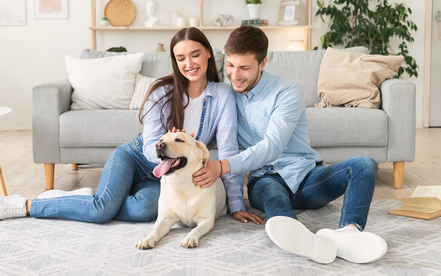 A young couple enjoying a cozy moment with their dog in the clean air Fil-Fresh air filters provide
