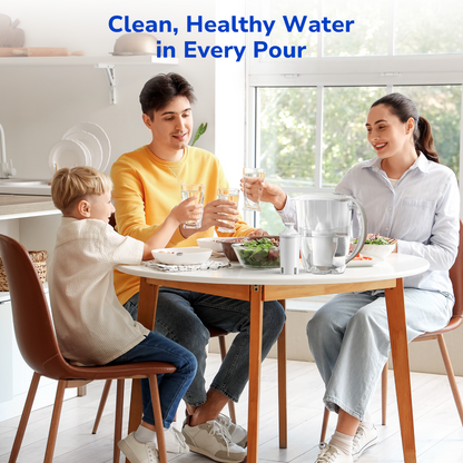 A smiling family of three toasting with glass cups at the dinner table, with a water pitcher using a Fil-Fresh filter providing clean, great-tasting water
