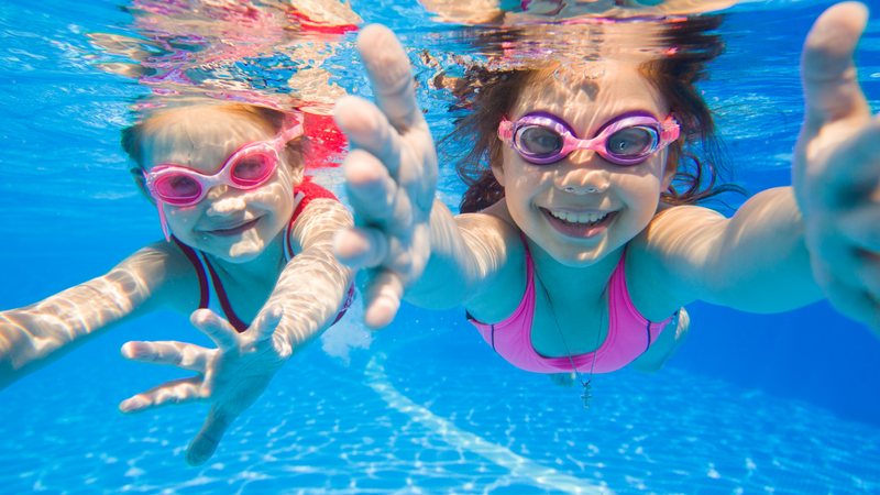 Happy kids swimming underwater in a pool kept clean and always ready for fun by Fil-Fresh filters