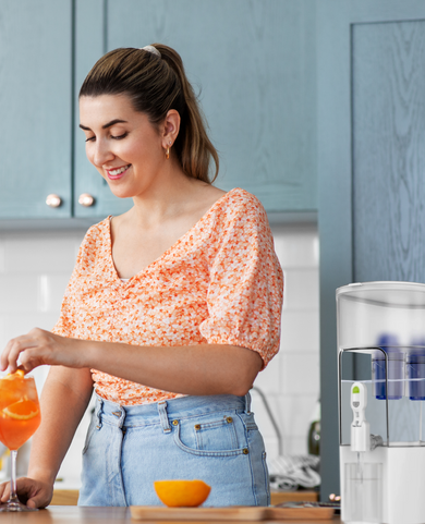 Young woman making drinks with water filtered by a Fil-Fresh replacement filter