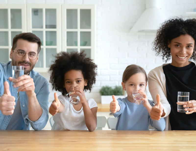 Happy family of four appreciating affordable and easy-to-change Fil-Fresh water filter delivering clean, great-tasting water