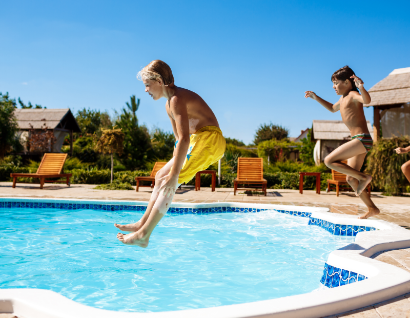 Joyful kids jumping into a sparkling clear pool maintained by Fil-Fresh high-performance and easy-to-clean pool filters
