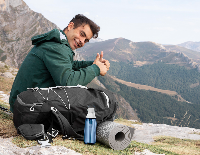 A man hiking outdoors with a Brita water bottle featuring a Fil-Fresh water bottle filter